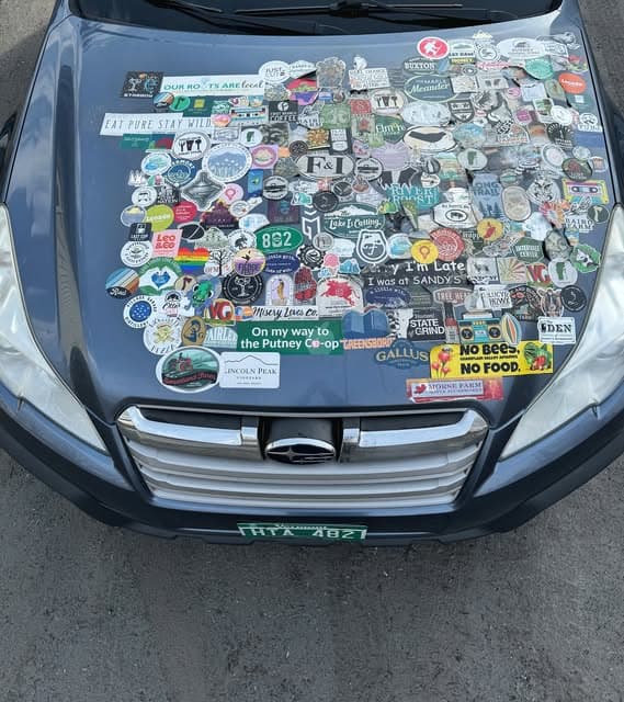 The Eat Vermont Subaru, its hood covered in stickers from local Vermont businesses