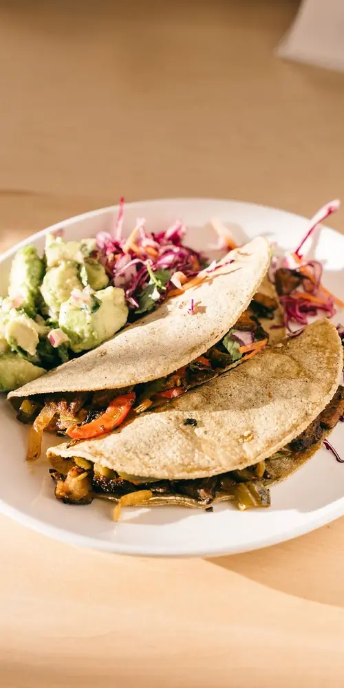 DC Tacos, On Warm corn tortillas with jack cheese. Served with cabbage salad & avocado salsa.