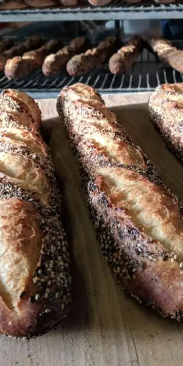 Hot out of the oven & off they go to local stores: Seeded Baguettes! 🌾Encrusted with our blend of or