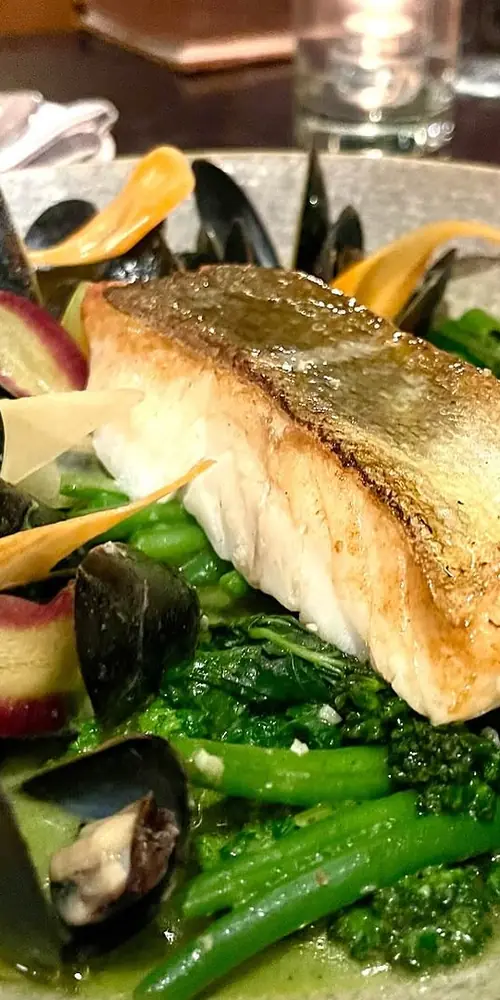 Dinner menu staple: Seared Cod filet with thai curry, mussels, green beans and shaved carrots. Dinne