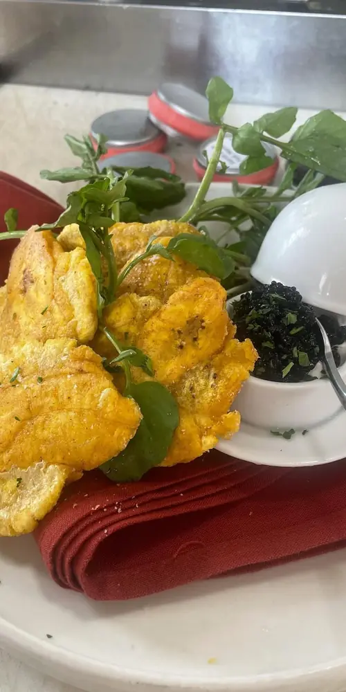 Chef Mark’s special tonight is warm tostones with sour cream and hackleback caviar. It is the perfec