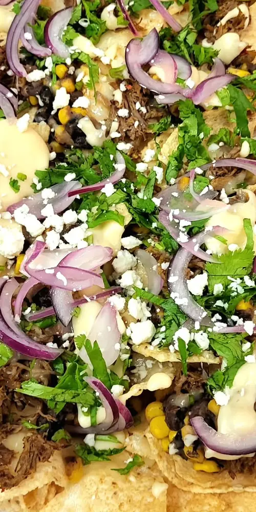 Early reviews are in: our nachos, with or without braised beef, rock! Covered in cheddar and Montere